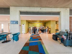 a lobby with a colorful rug on the floor at Mercure Tallinn in Tallinn +126 photos