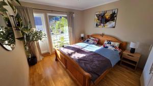 a bedroom with a bed and a large window at Lovely Home In Sauda With Wifi in Sauda