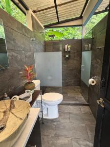 a bathroom with two toilets and a sink at Osaglamping in Palmar Norte