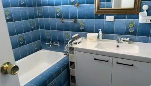 a blue tiled bathroom with a sink and a tub at Mains Rd 舒适双人间2张床2 in Brisbane +24 photos