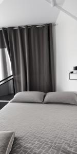 a bedroom with a bed with a black curtain at Homestay A&R Home in Yan