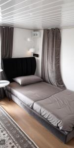 a bed sitting in a room with a window at Homestay A&R Home in Yan +80 photos