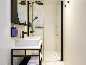 a bathroom with a sink and a shower at Tribe Paris La Defense Esplanade in Courbevoie