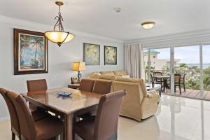 a living room with a table and a couch at Beachfront - Best View 2BR condo - E422-2 in Palm-Eagle Beach