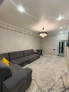 a living room with a couch and a table at Urban oasis in Bishkek