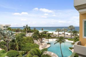 an aerial view of a resort with a pool and the ocean at Beachfront - Best View 2BR condo - E422-2 in Palm-Eagle Beach
