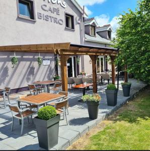 a patio with tables and chairs in front of a cafe at Hatton's of Garadice in Garadice