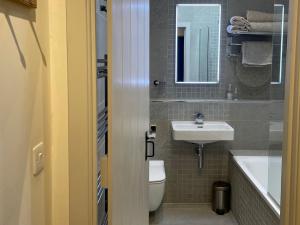 a bathroom with a white toilet and a sink at 1 Bed in Ullswater 94068 in Watermillock