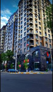a large building on a city street with a traffic light at Urban oasis in Bishkek