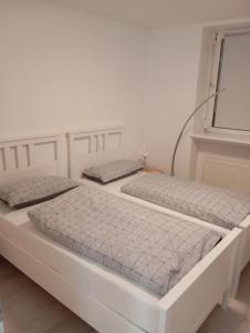 two beds sitting next to each other in a room at Teuchern in Teuchern