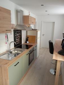 a kitchen with a sink and a stove top oven at Teuchern in Teuchern