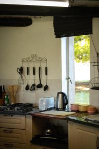 a kitchen with a stove and utensils on the wall at Blackbrook Farm Underberg in Underberg