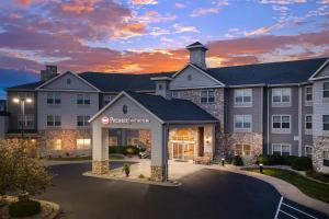 a rendering of the front of a hotel at sunset at Best Western Premier Bridgewood Hotel Resort in Neenah