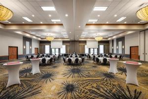 a large banquet hall with tables and chairs and chandeliers at Best Western Premier Bridgewood Hotel Resort in Neenah +68 photos
