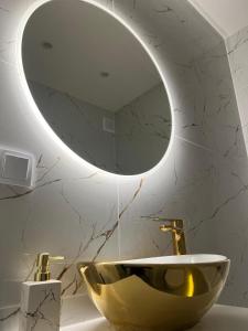 a bathroom with a bowl sink and a mirror at Nowe luksusowe Apartamenty MANUFAKTURA-Prywatny na wyłączność-Wanna-Zamykany ogrodzony Parking, Blok,Niskie pietro-cisza i spokój in Łódź