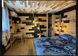 a bedroom with a bed with a dragon painted on it at le valhalla odin in Forges-les-Eaux