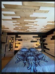 a bedroom with a bed with a dragon painted on it at le valhalla odin in Forges-les-Eaux