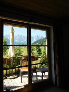 a window with a view of a mountain view at Appartements gosaukamm.com in Gosau