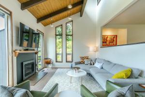 a living room with a couch and a fireplace at 3 min to UO with amazing views! Central to all! in Eugene