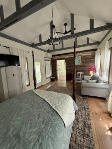 a bedroom with a bed and a couch at Courtyard by Ravens Keep in Jackson