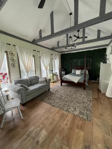 a living room with a couch and a bed at Courtyard by Ravens Keep in Jackson