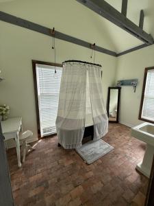 a bathroom with a curtain in a room with a sink at Courtyard by Ravens Keep in Jackson