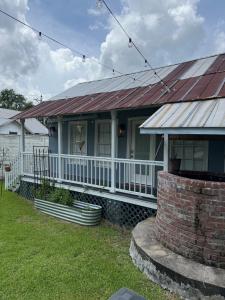a house with a rusted tin roof on a porch at Courtyard by Ravens Keep in Jackson