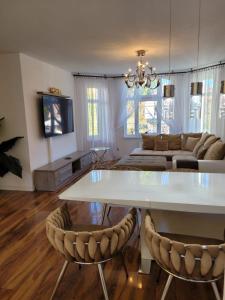 a living room with a white table and chairs at Portofino Apartamenty in Ustka
