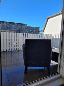 a chair sitting on a balcony next to a fence at Portofino Apartamenty in Ustka +18 photos