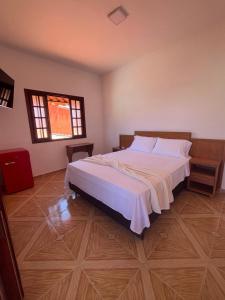 a bedroom with a large bed and a window at Casa Mar-A-Lagoa in São Pedro da Aldeia +44 photos