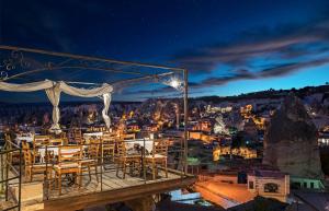 a restaurant with a view of a city at night at Aydinli Cave Hotel in Göreme