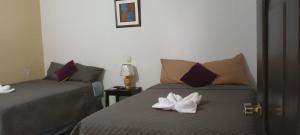 a hotel room with two beds with towels on it at Hotel La Villa in Retalhuleu