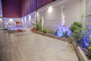 a room with a table and chairs and plants at استراحة غريس الجديدة in Jeddah
