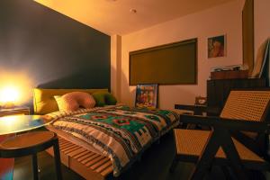 a bedroom with a bed and a table and a tv at MusicInn Matoya - Vacation STAY 62103v in Sumoto
