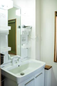 a white bathroom with a sink and a mirror at MusicInn Matoya - Vacation STAY 62103v in Sumoto +52 photos