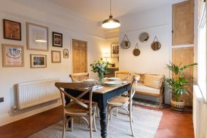 a dining room with a table and chairs at Bishy Hill Town House in York in York