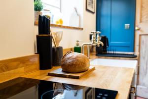 a loaf of bread sitting on a cutting board on a counter at Bishy Hill Town House in York in York +26 photos