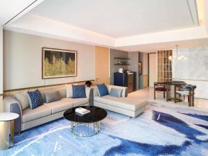 a living room with a couch and a table at Fairmont Ambassador Seoul in Seoul +135 photos