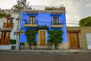 a blue building with plants in front of it at Del Mar Guest House in Cartagena de Indias