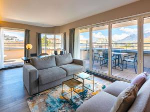 a living room with a couch and a table at Le Splendid Hotel Lac D'Annecy - Handwritten Collection in Annecy +193 photos
