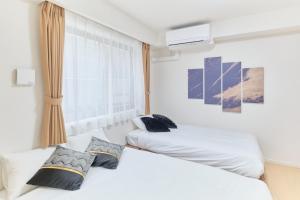 Postel nebo postele na pokoji v ubytování J-ARC Akebonobashi - Vacation STAY 17364