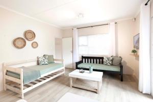 a bedroom with a bed and a couch and a table at Hilton House One in Hilton