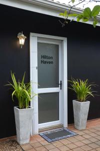 a glass door with plants in front of a building at Hilton House One in Hilton +11 photos
