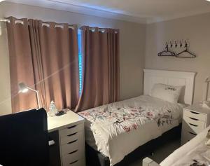 a bedroom with a bed and a desk and a window at UQ big room 2 bed for 2 people1 in Brisbane