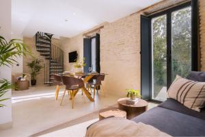 セビリアにあるLuxurious Duplex 2Bd 2Bth over Casa Pilatosのソファとテーブルと椅子のあるリビングルーム