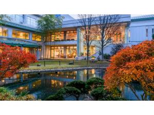 an office building with a pond in front of it at Hotel Symphony - Vacation STAY 67006v in Sagae