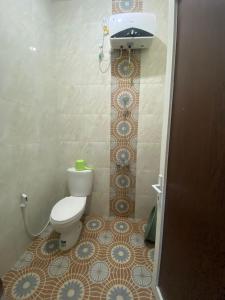 a bathroom with a toilet and a sink at Serene Villa in Batu with 3 Bedrooms and a Rooftop in Batu +9 photos