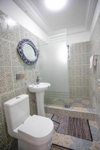 a bathroom with a toilet and a sink and a mirror at My Little Home - Miz Platzli in Ashalebotwe