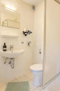 a bathroom with a toilet and a sink at Waldhotel Bad Münstereifel in Bad Münstereifel