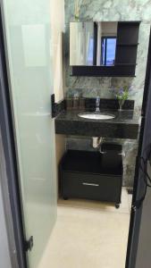 a bathroom with a sink and a mirror at Flats containers in Rio Verde